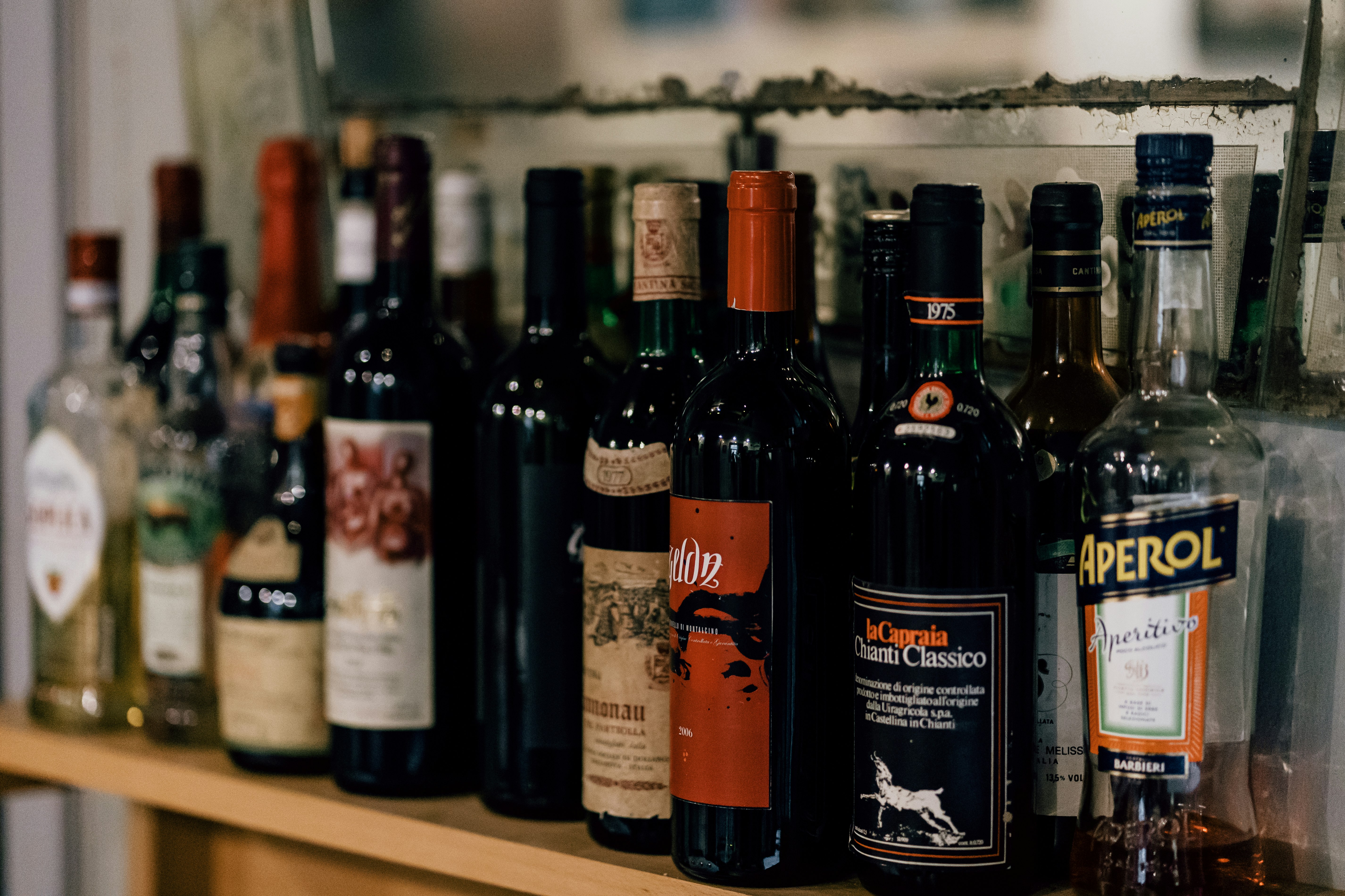 A shelf full of Italian wine and spirits in a trattoria