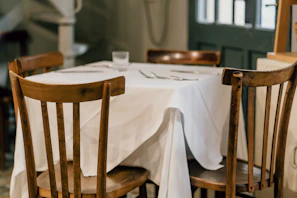Dining nook with a wooden table set for four.