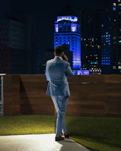 A friendly roofing expert answering a phone call in front of a residential home in Toronto.