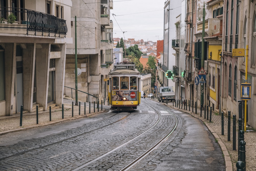 yellow and white tram on the street