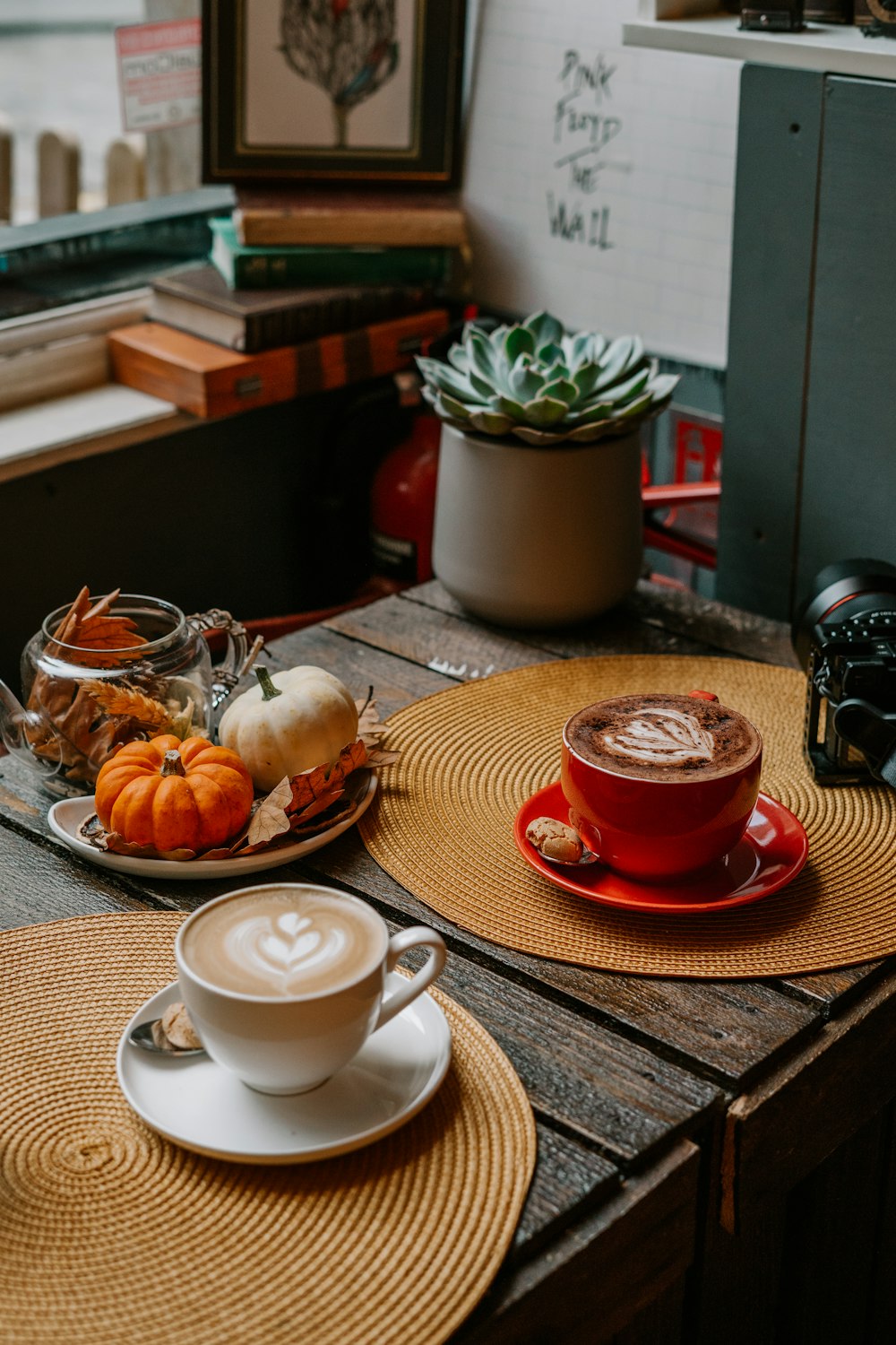 white ceramic teacup on red saucer