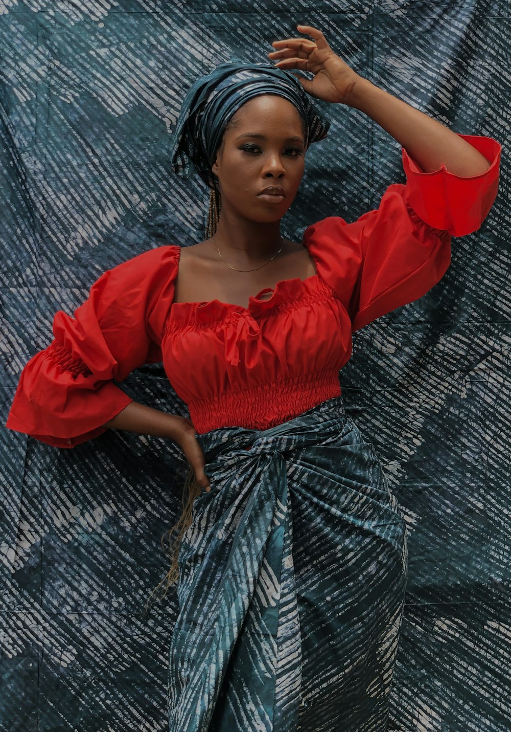 woman in red dress holding her hair