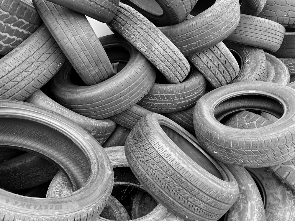 grayscale photo of a pile of round metal