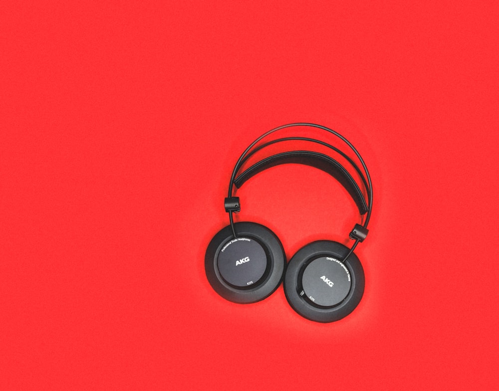 black headphones on red surface