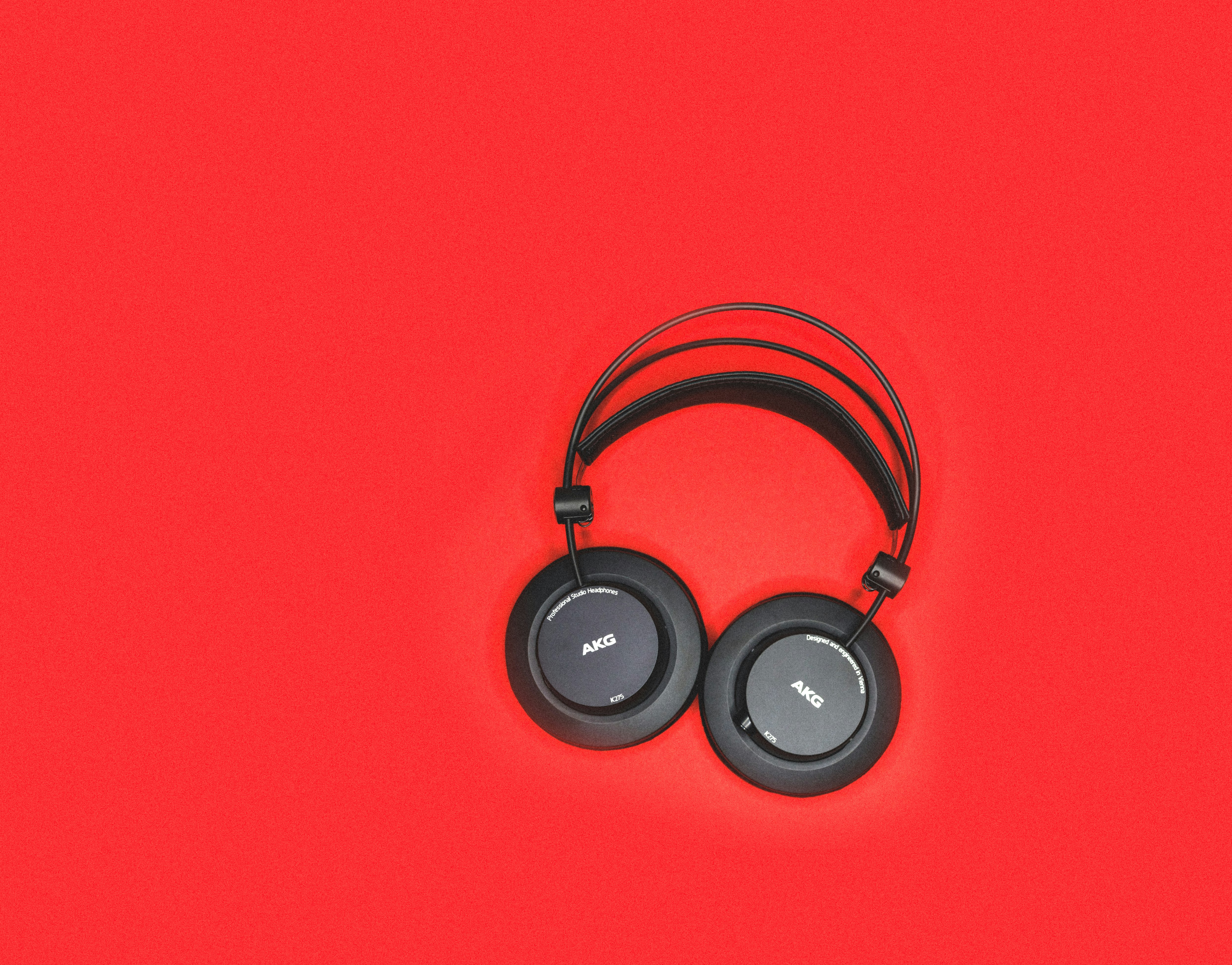black headphones on red surface