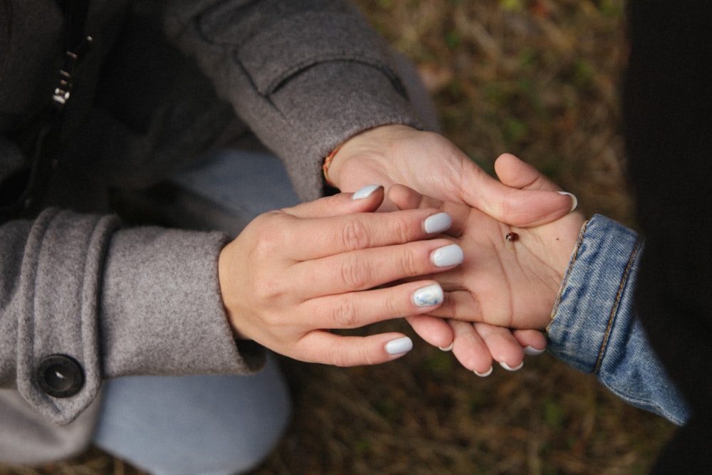 person in gray long sleeve shirt with white manicure