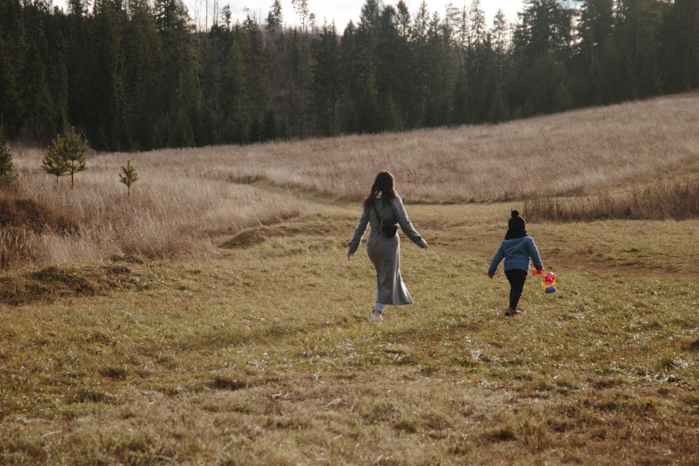 people walking on green grass field during daytime