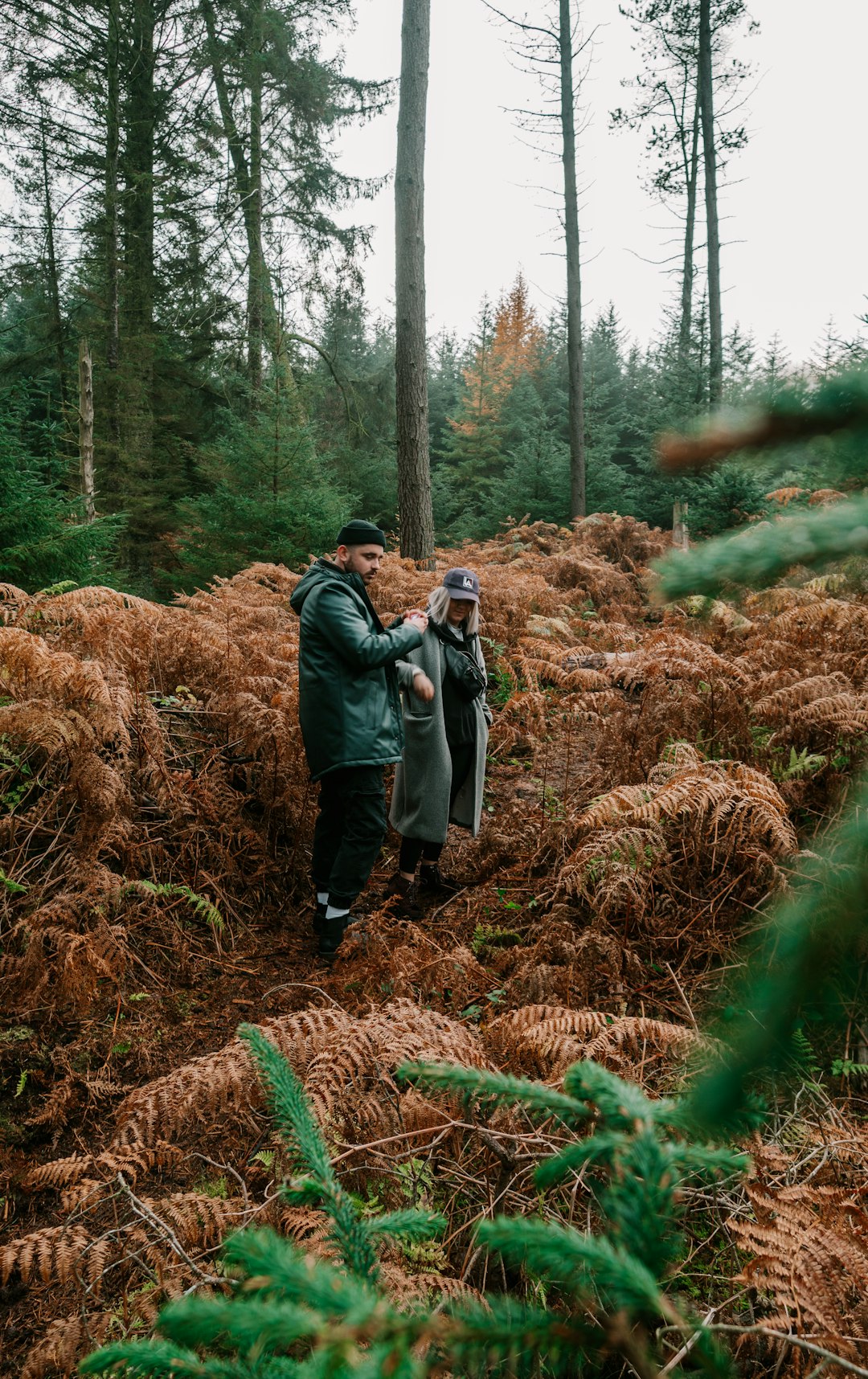 man and woman walking on brown grass field during daytime