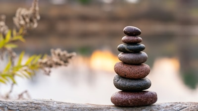 brown stone stack on brown wooden log