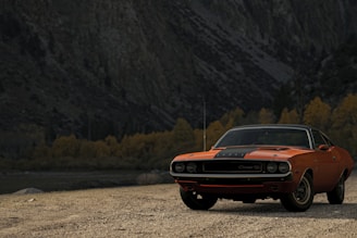orange chevrolet camaro on dirt road during daytime