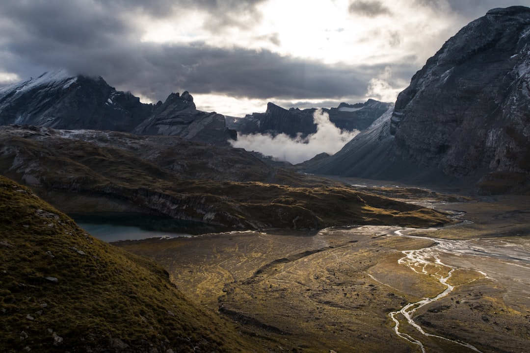 brown and green mountains under white clouds during daytime