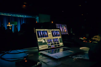 black laptop computer turned on on table