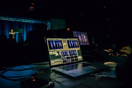 black laptop computer turned on on table