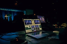 black laptop computer turned on on table