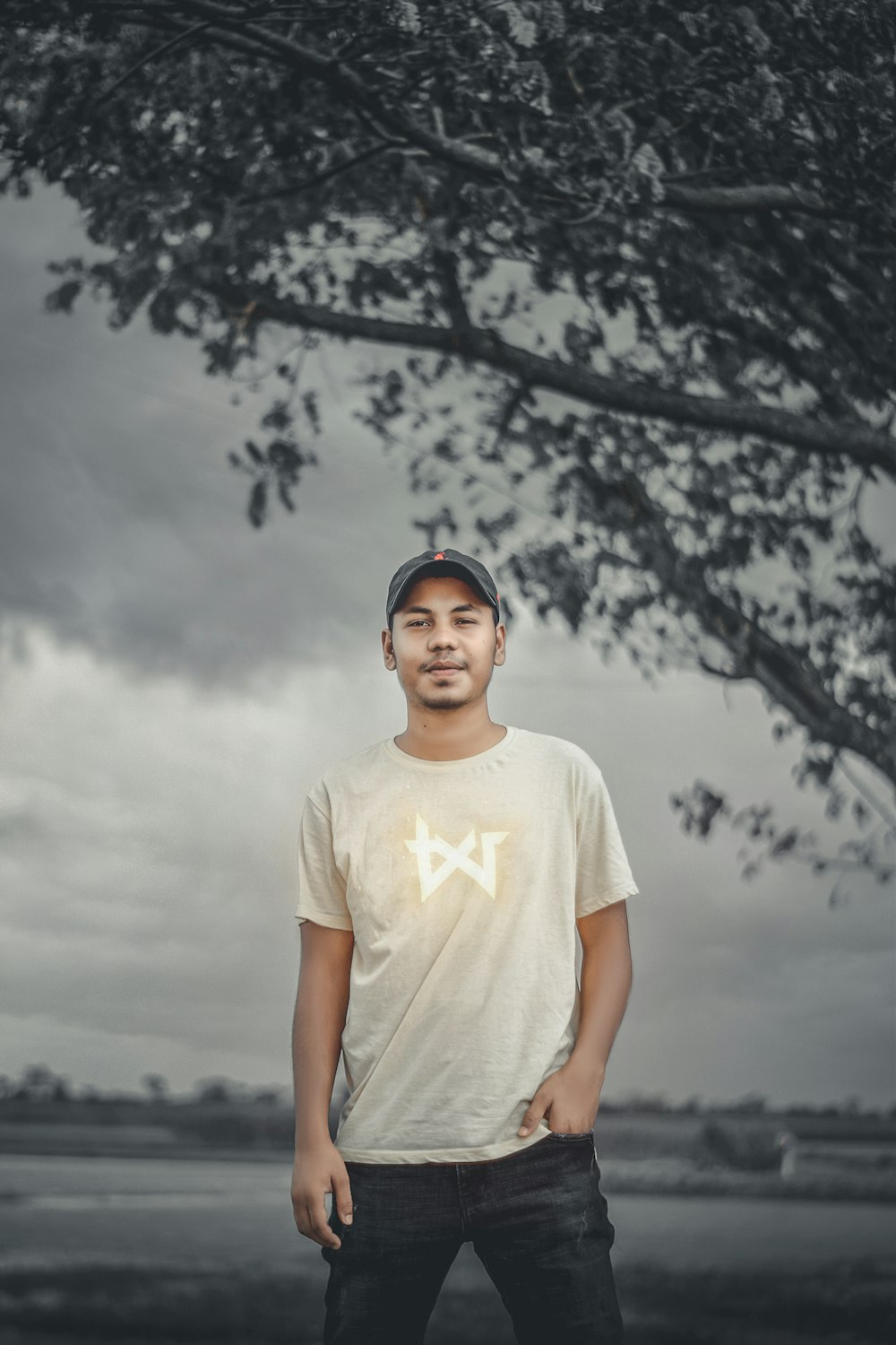 man in white crew neck t-shirt standing under white sky during daytime