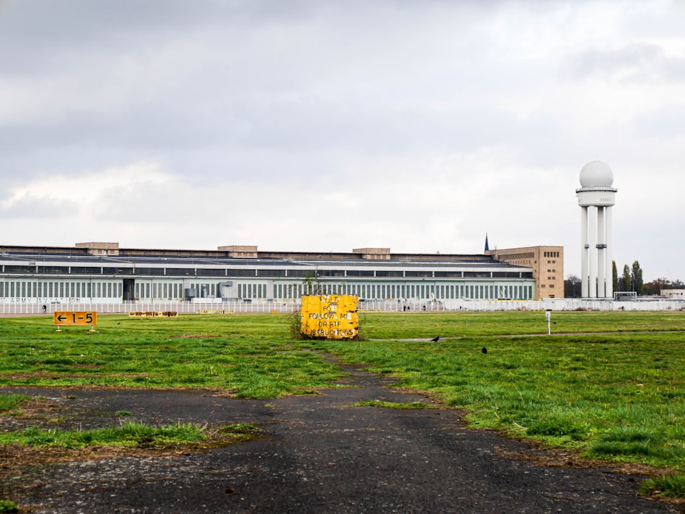 white concrete building near green grass field during daytime