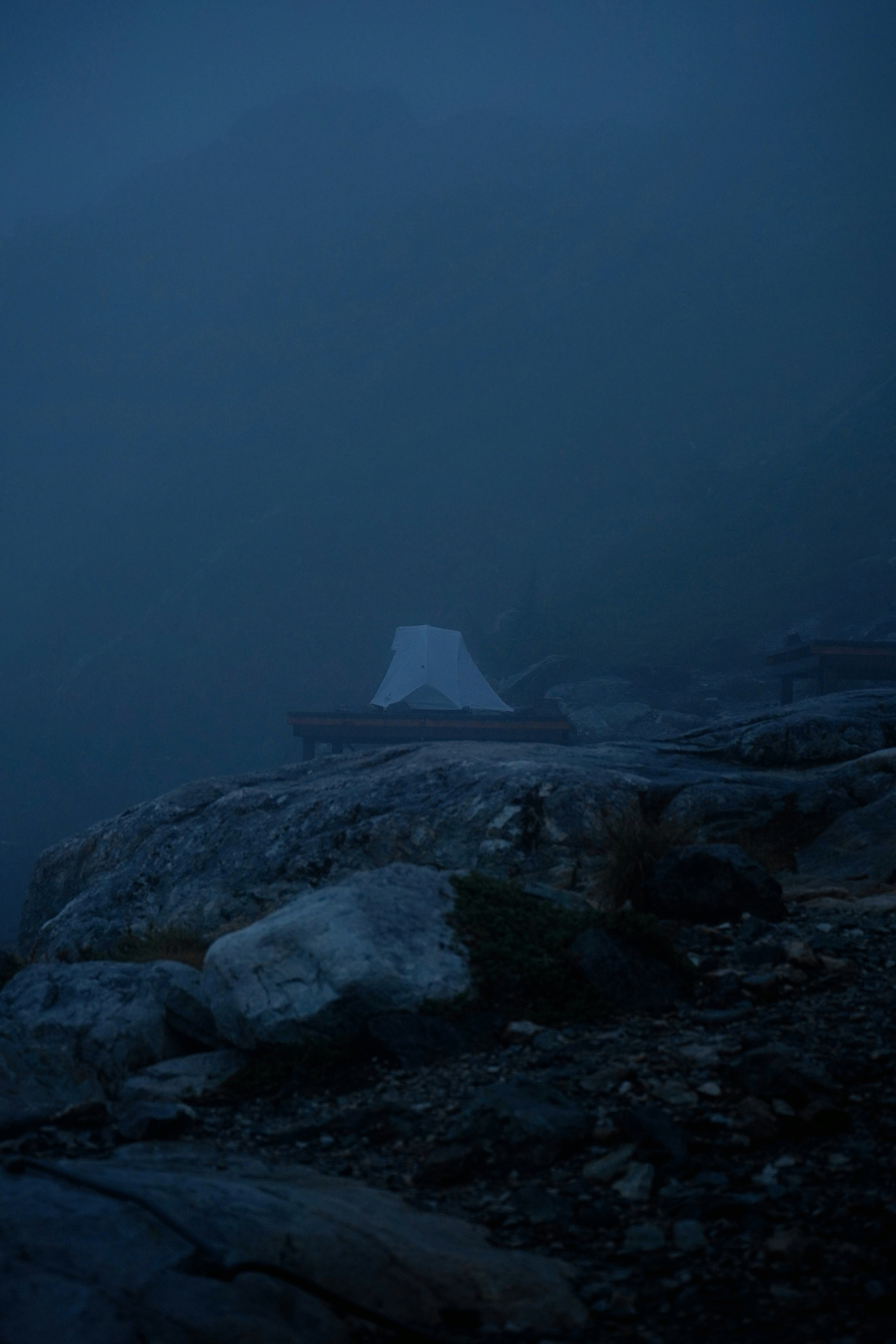 person sitting on rock formation during night time