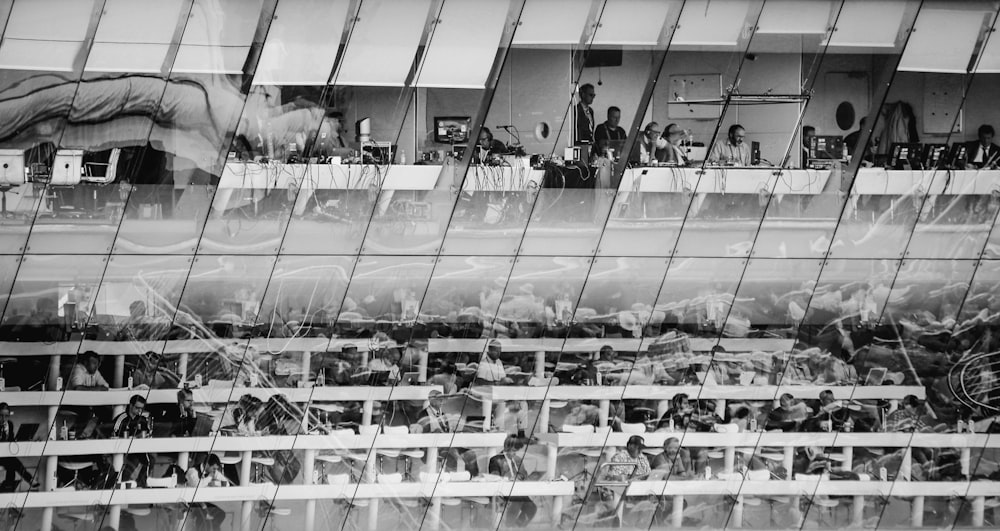 grayscale photo of people in a building
