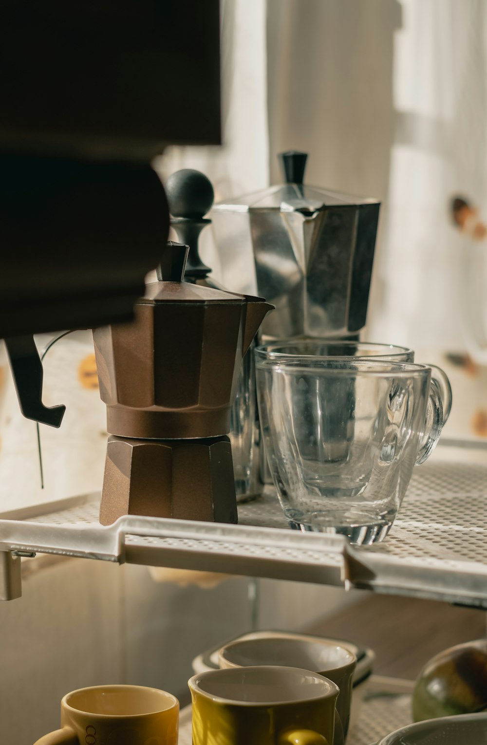 clear drinking glass on stainless steel coffee maker