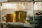 Close-up of a bamboo dish drying rack holding plates and cups in a bright kitchen.
