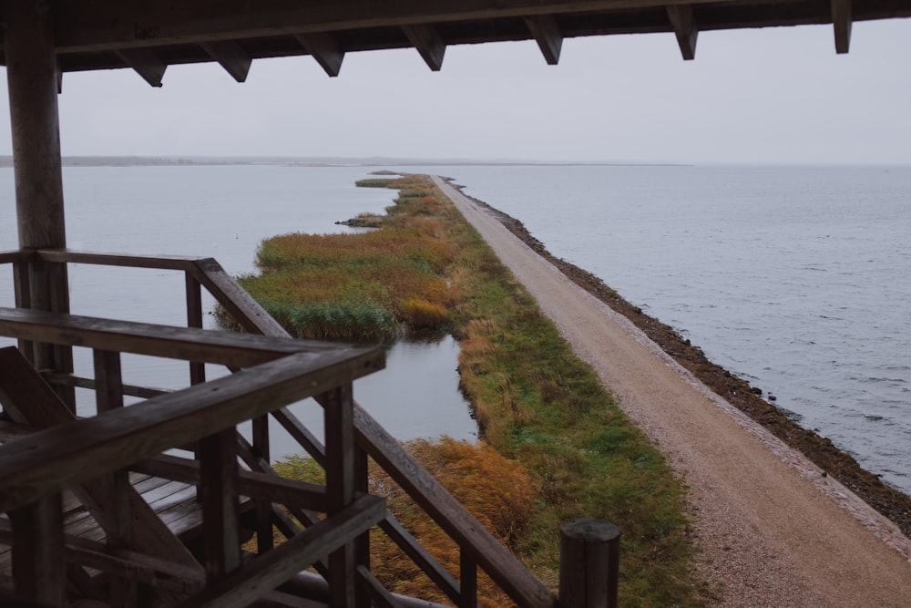 brown wooden bridge over body of water during daytime