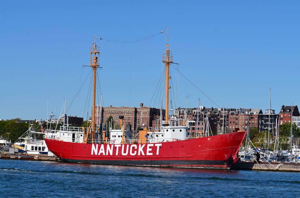 red and white boat on sea during daytime