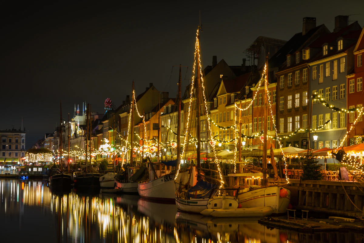 Nyhavn harbour in Copenhagen decorated with Christmas lights in the evening