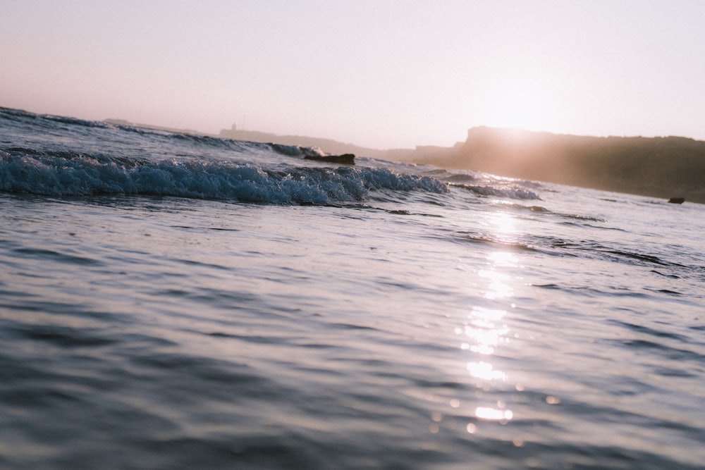 ocean waves crashing on shore during daytime