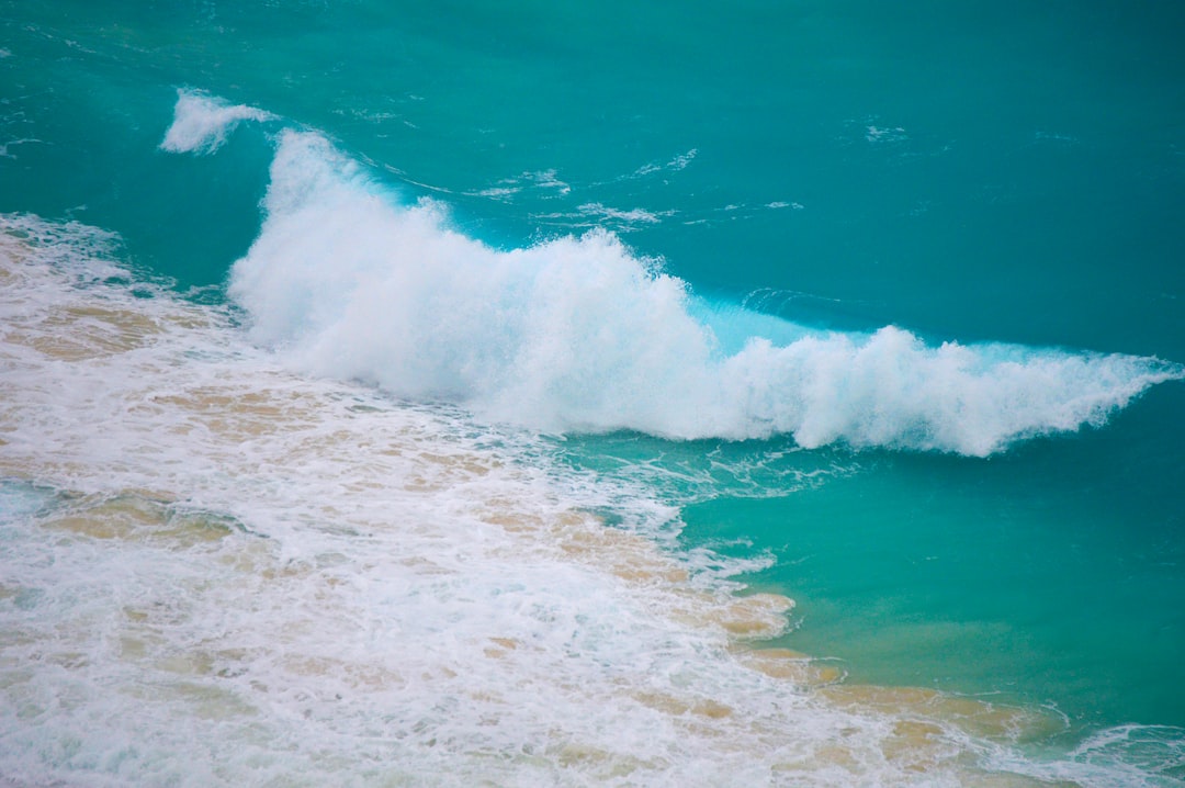 ocean waves crashing on shore during daytime