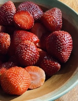 strawberries on brown wooden bowl