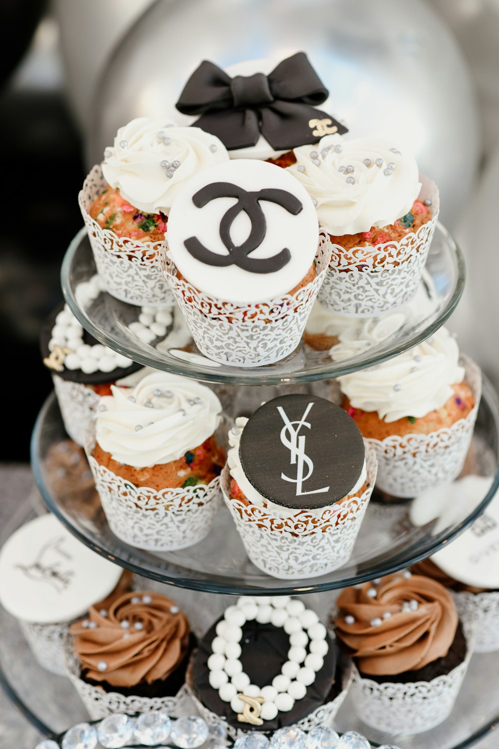 white and brown cupcakes on clear glass tray