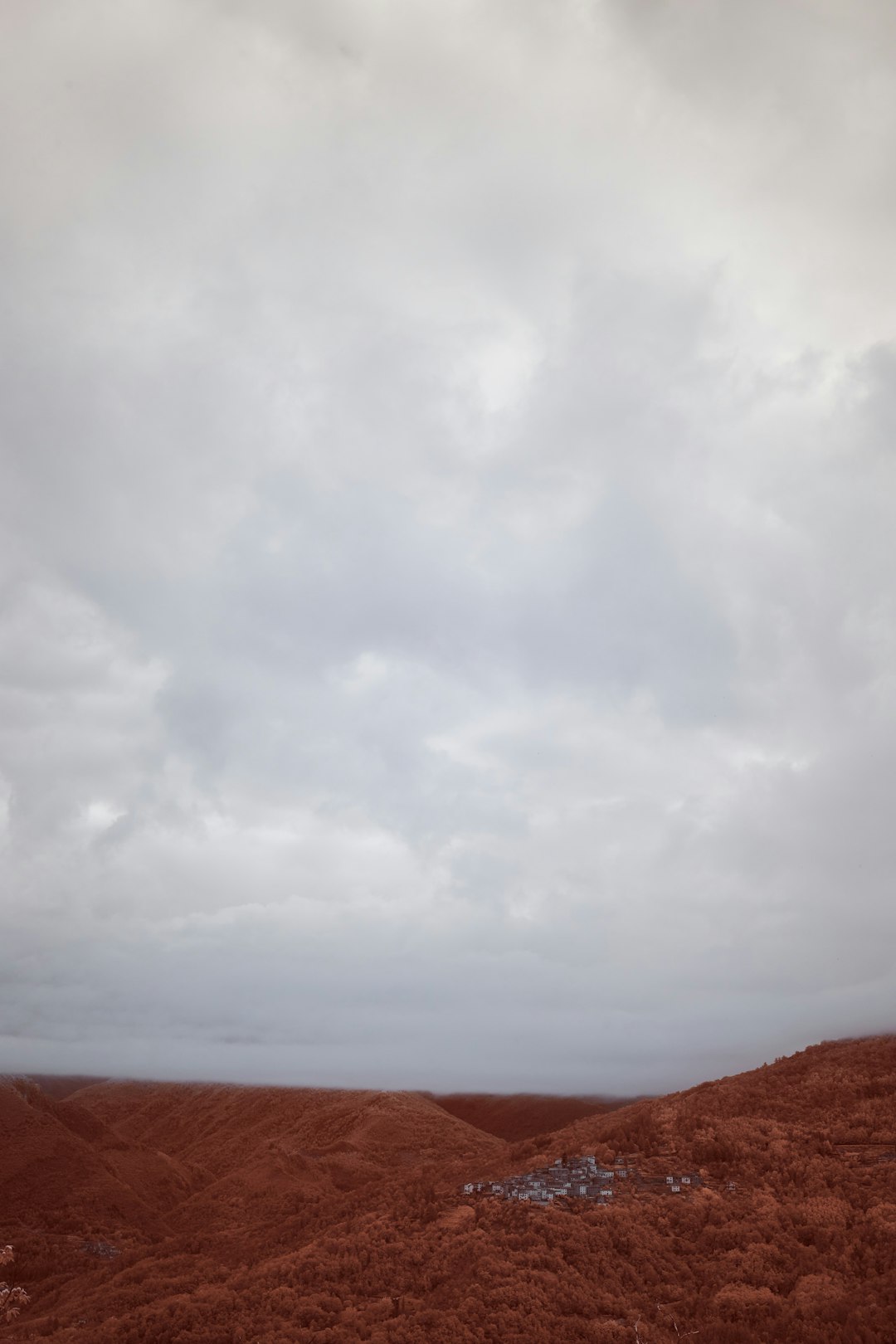 brown mountain under white clouds during daytime