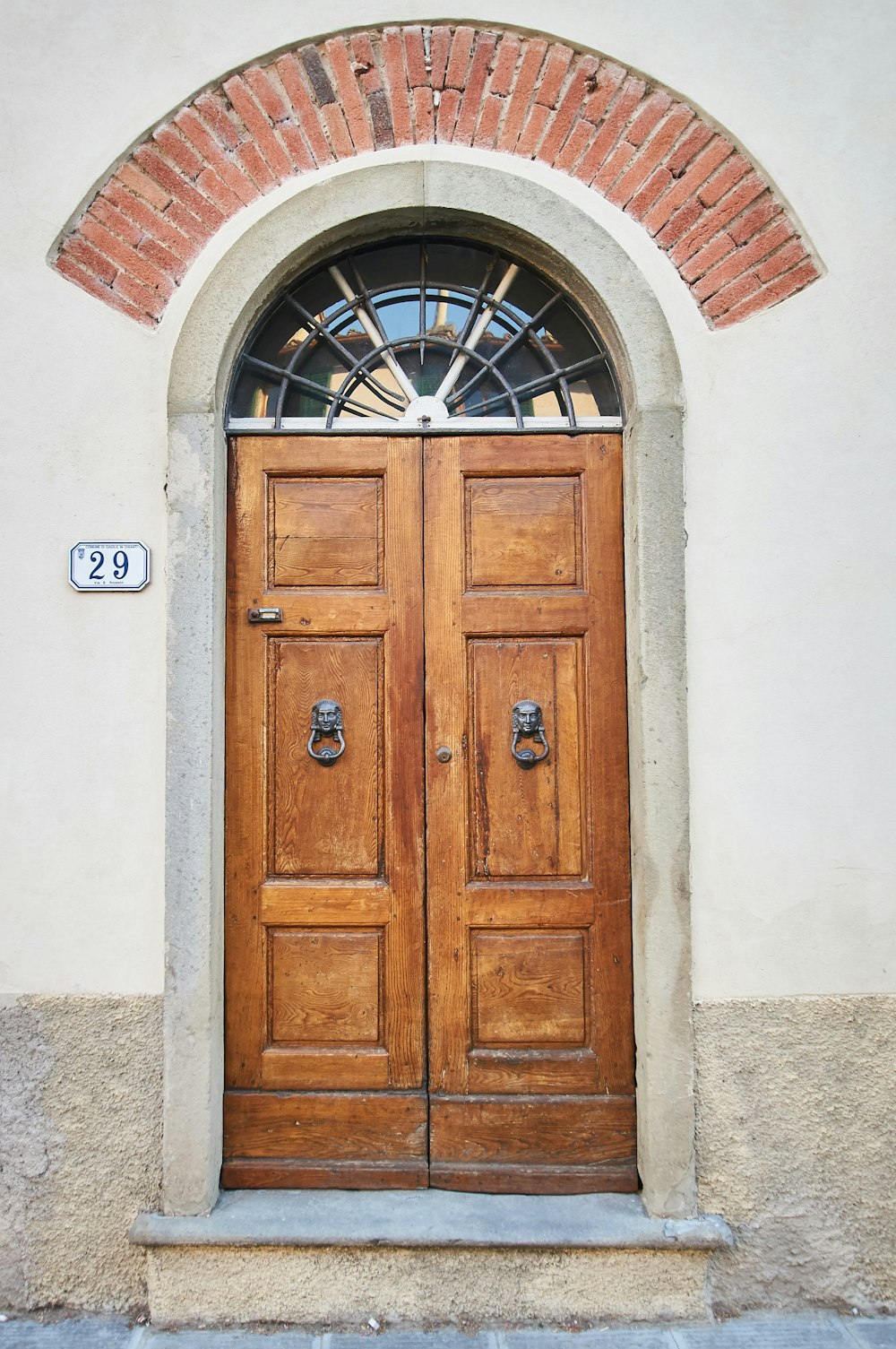 brown wooden door on white concrete wall