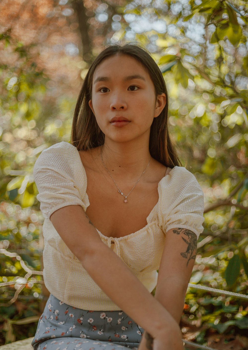 woman in white scoop neck long sleeve shirt wearing silver necklace