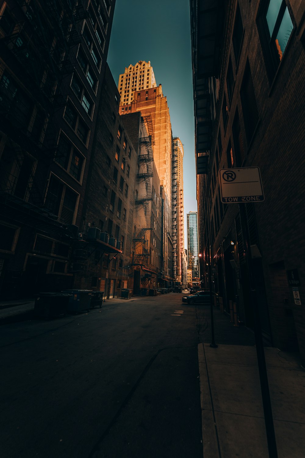 people walking on sidewalk near high rise buildings during night time