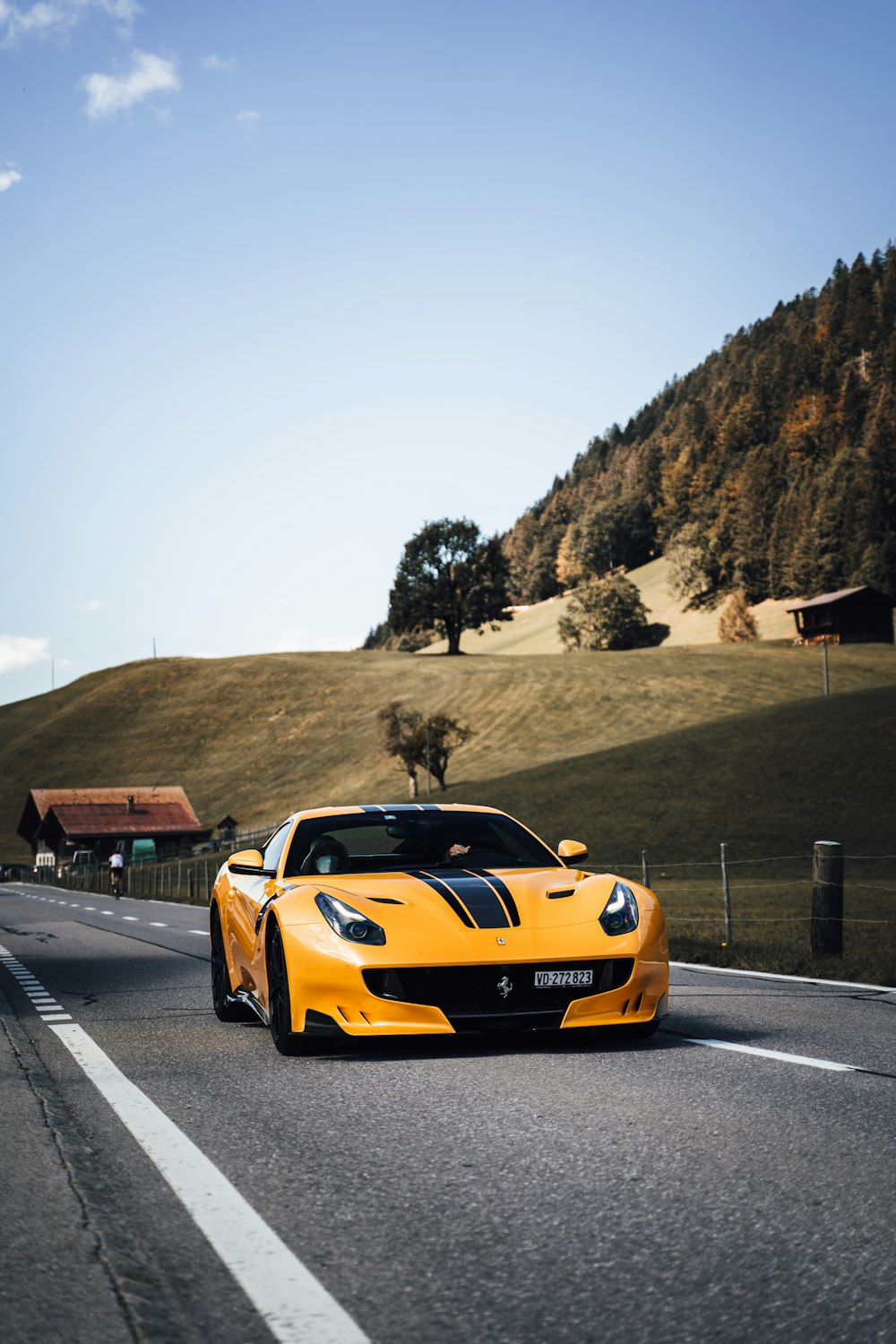 yellow ferrari car on road during daytime