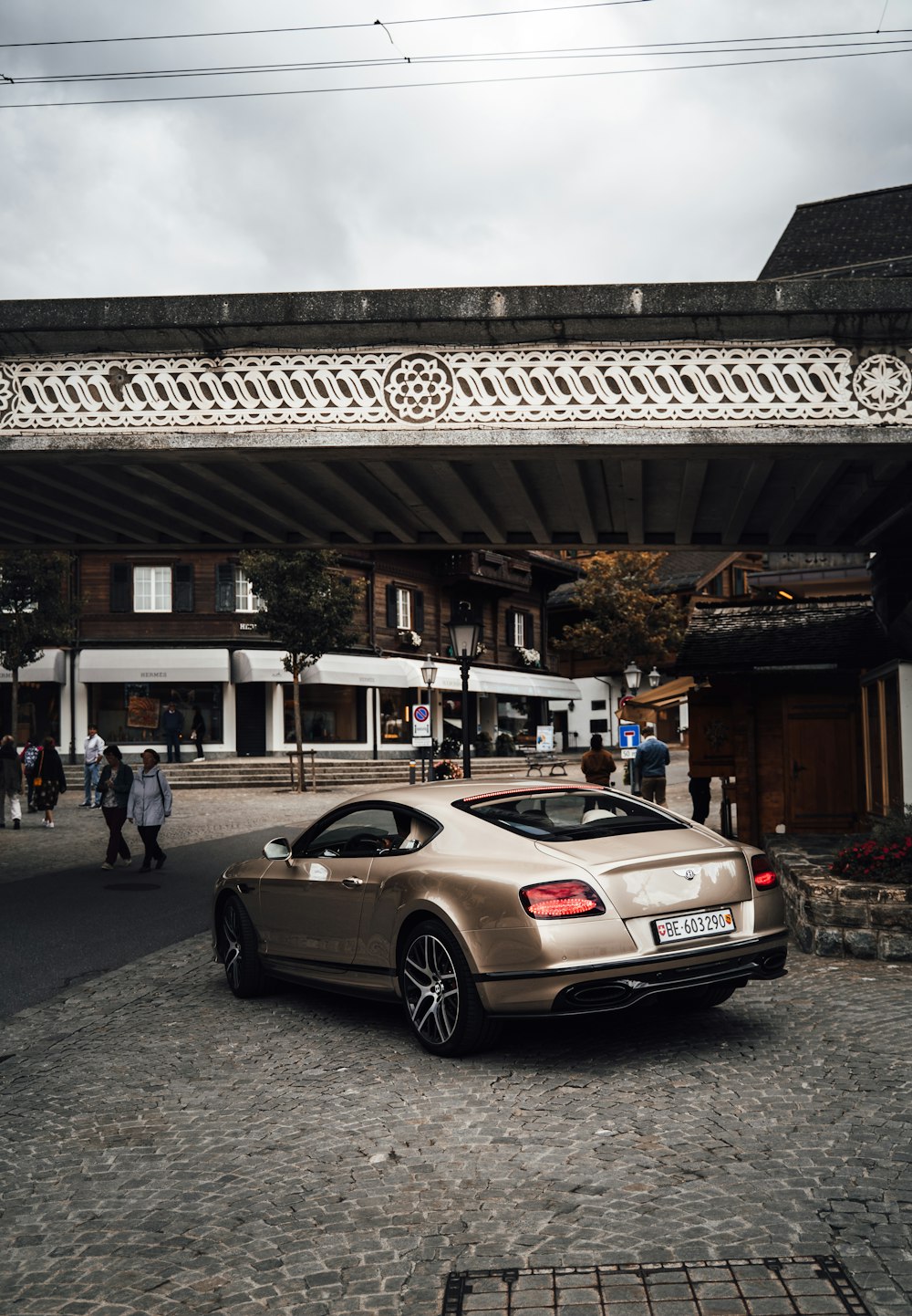 white mercedes benz coupe parked near building during daytime