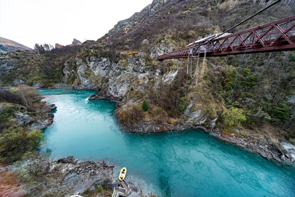 people in a river near a bridge during daytime