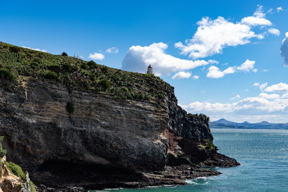 person standing on cliff during daytime