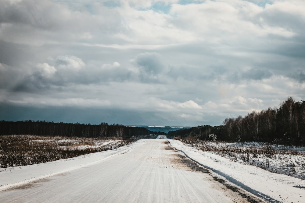 snow covered road during daytime