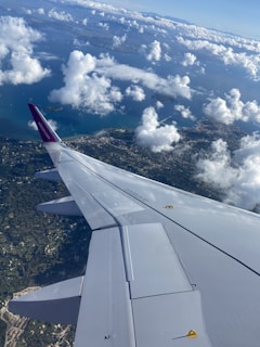 A scenic view of a travel destination with a plane flying in the sky.
