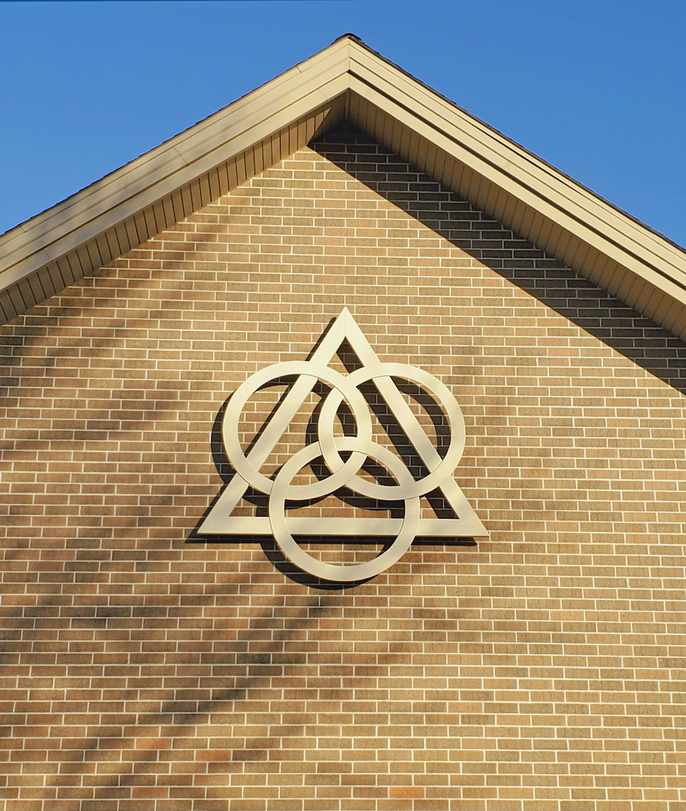 brown brick wall with white cross