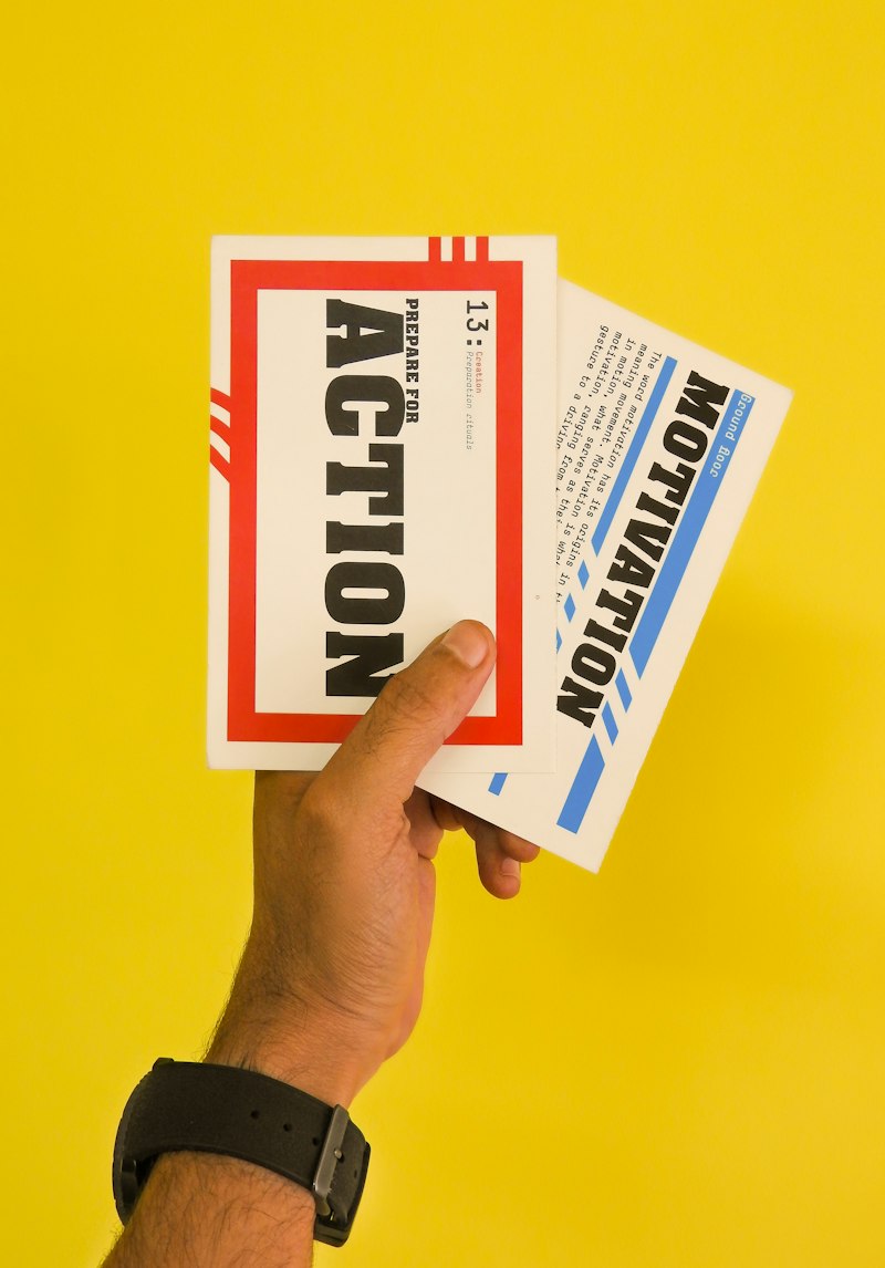 Hand holding a yellow leaflet with a motivation message