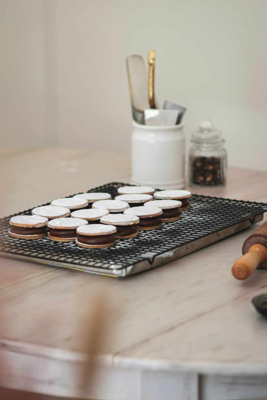 chocolate cookies on tray beside milk in glass jar