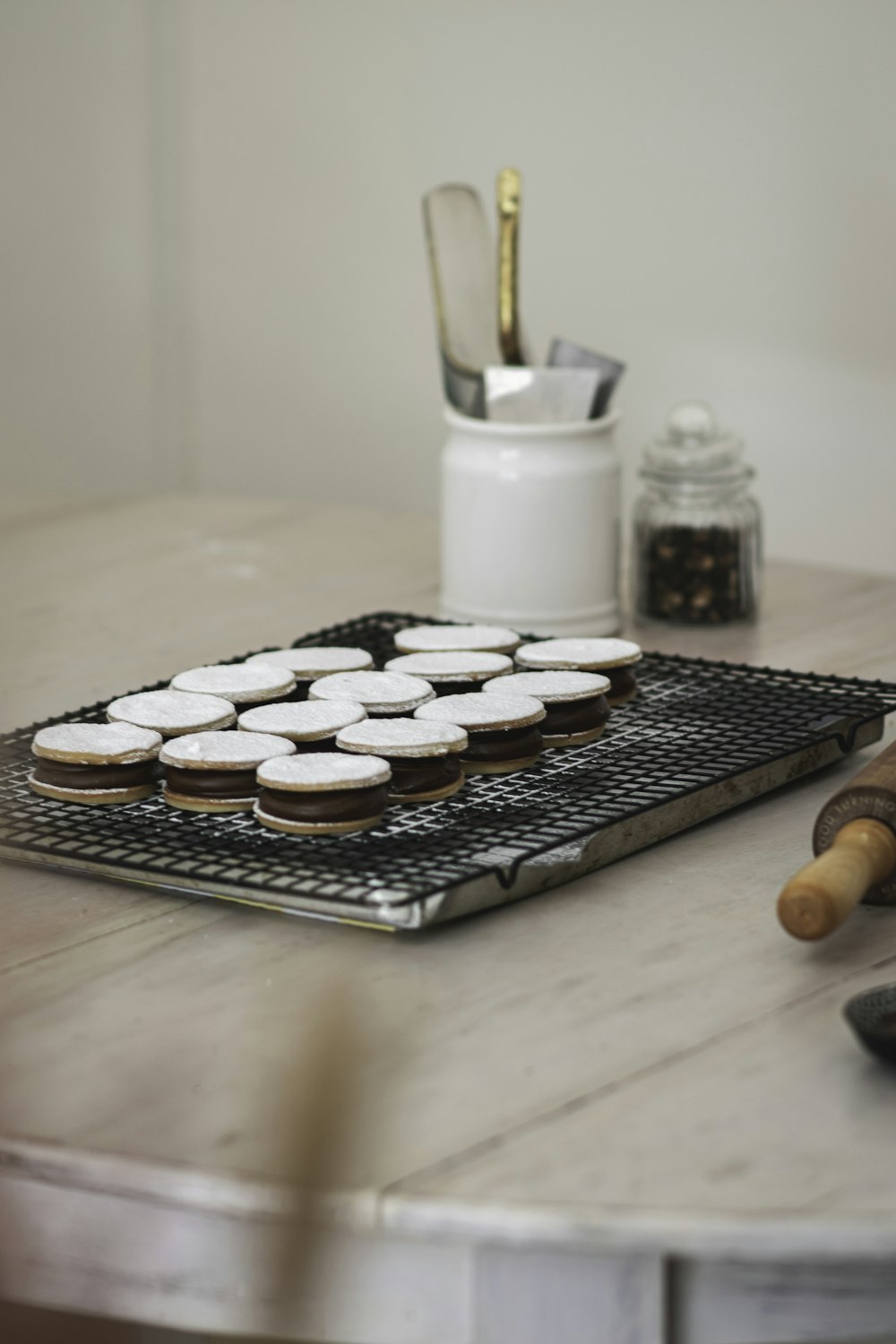 chocolate cookies on tray beside milk in glass jar