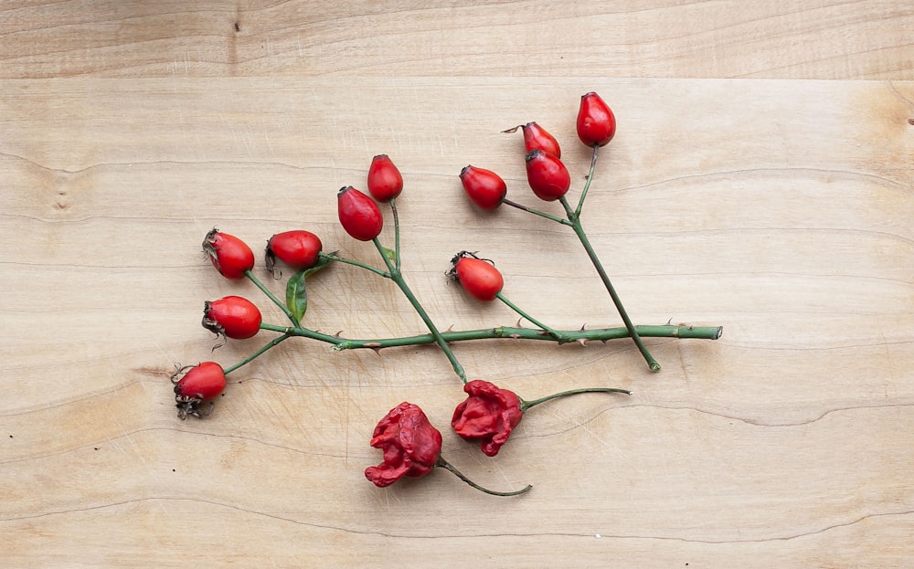 red rose on brown wooden table