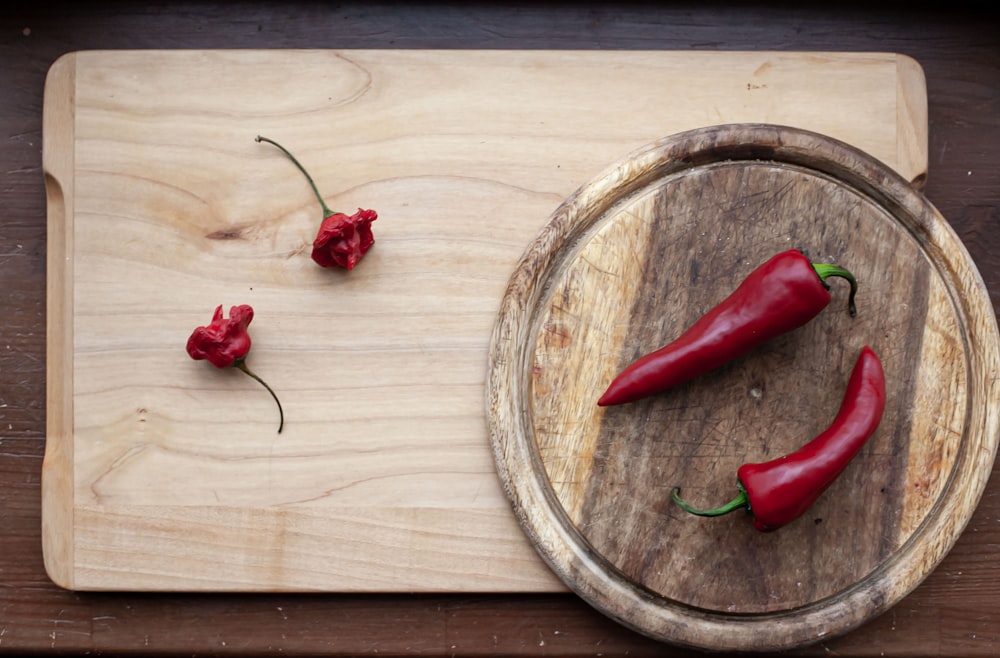 red chili pepper on brown wooden round plate