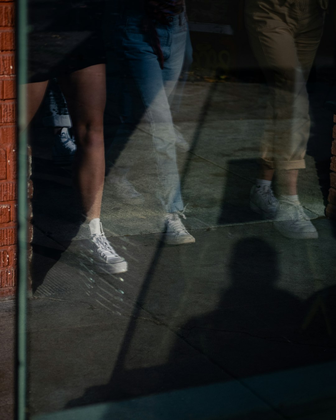 person in blue denim jeans and white sneakers