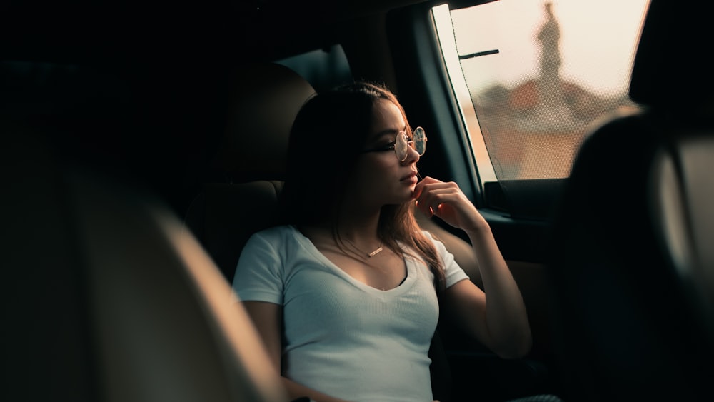 woman in white shirt sitting inside car