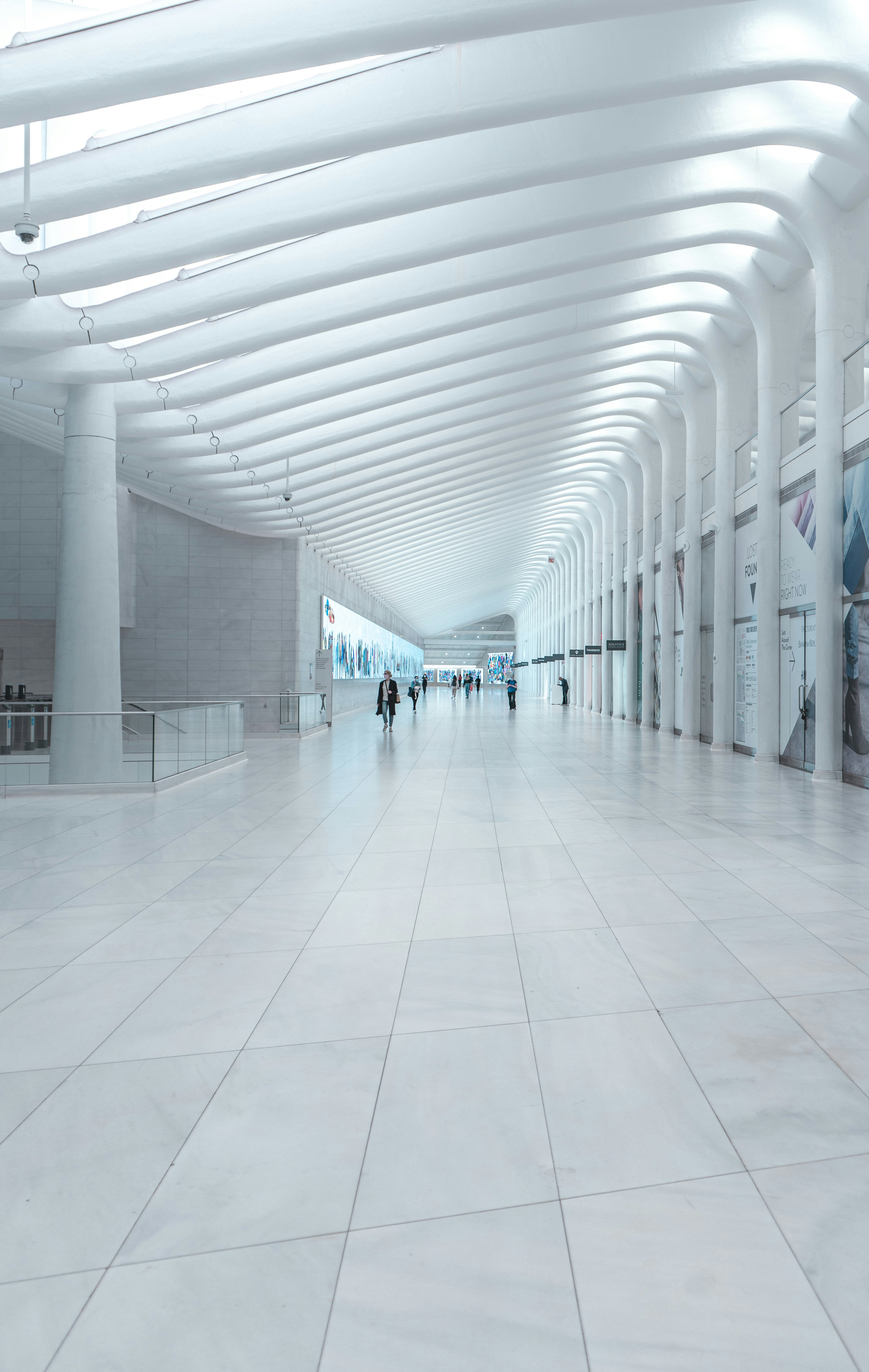 white tiled hallway with white walls